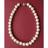 A cultured pearl necklace set with large barrel shaped pearls to a 9ct white gold concertina style