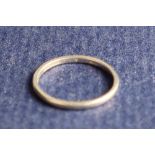 A platinum wedding band, size N, approximately 2.