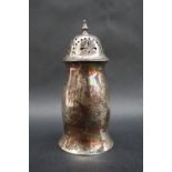 A George V silver sugar caster with a turned finial and pierced domed lid,