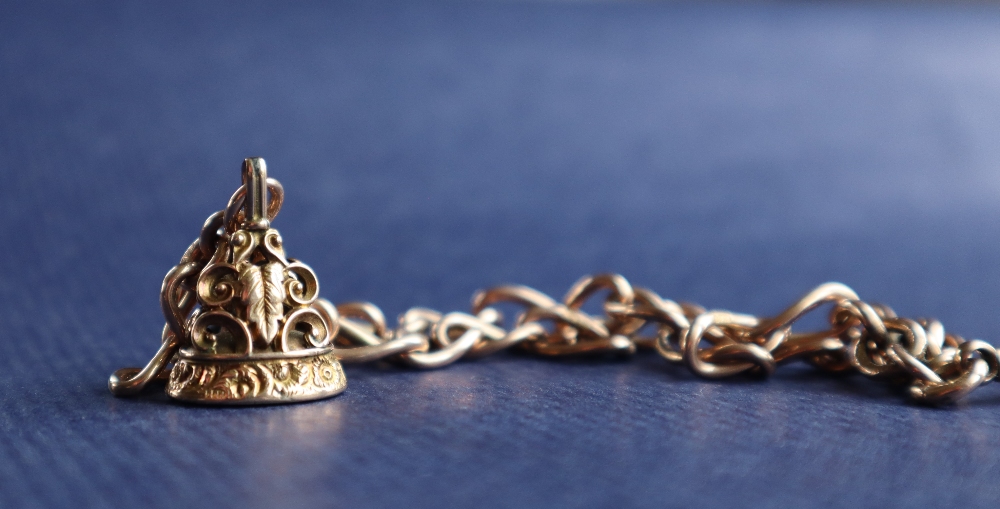 A 9ct yellow gold bracelet made from an Albert chain with twisted oval links and a yellow metal - Image 3 of 4