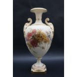 A large Royal Worcester twin handled vase with a flared rim and scrolling handles,