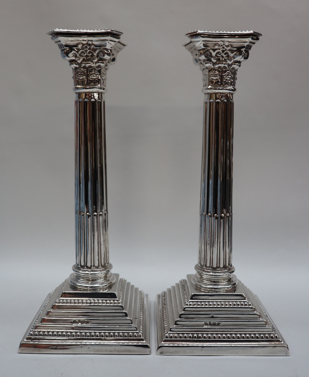 A pair of Elizabeth II silver corinthian column candlesticks with a stop fluted column and stepped - Image 3 of 4