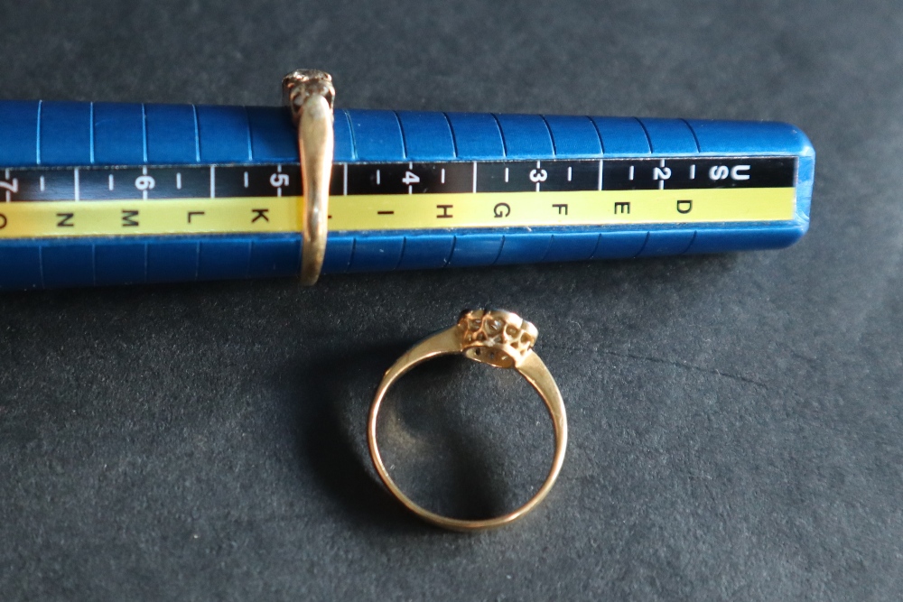 A three stone diamond ring, set with round old cut diamonds to a yellow metal setting and shank, - Image 4 of 4