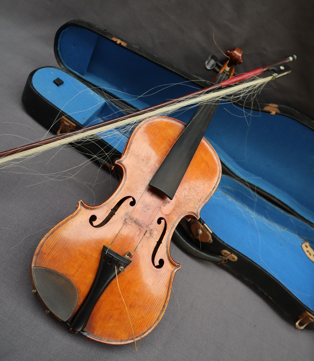 A three quarter size violin, with a two piece back and ebony stringing, bears a label El Tesoro,