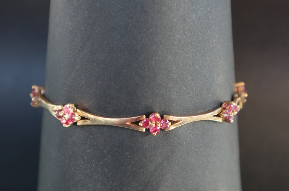 A 14ct yellow gold bracelet set with eight clusters of four rubies, 19cm long,