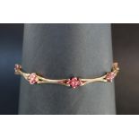 A 14ct yellow gold bracelet set with eight clusters of four rubies, 19cm long,