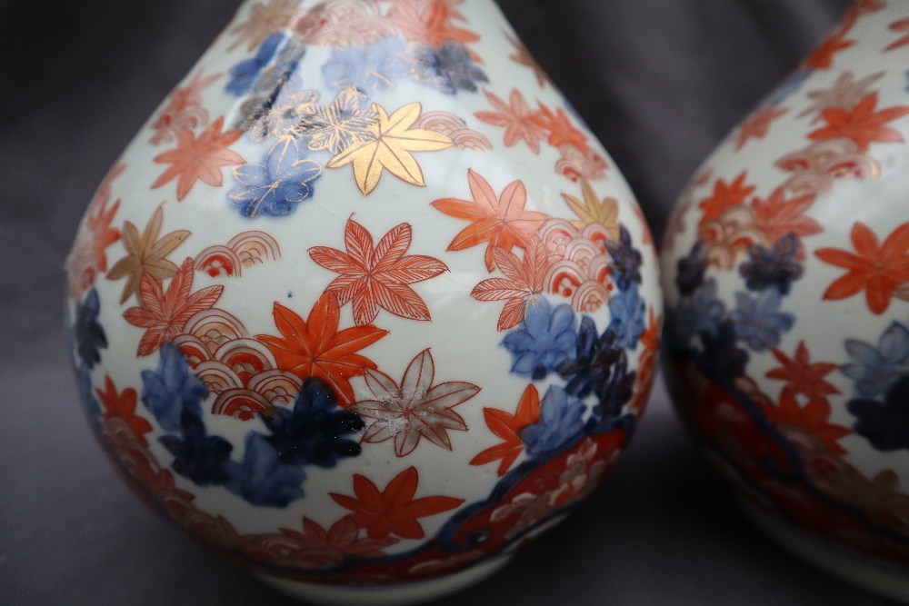 A pair of Japanese Imari pattern vases with a flared neck and tapering body, - Image 4 of 6