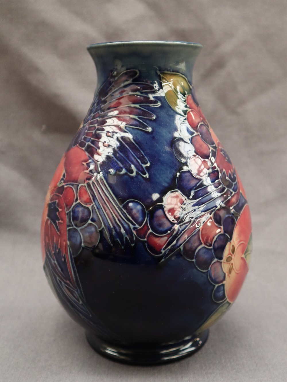 A Moorcroft pottery vase decorated with birds and fruit to a royal blue ground, - Image 5 of 9