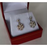 A pair of diamond set cluster drop earrings,