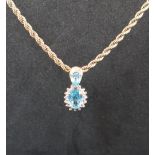 A topaz and diamond cluster drop pendant,