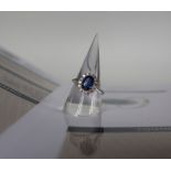 An 18ct white gold kyanite and diamond cluster ring set with an oval faceted Kyanite approximately