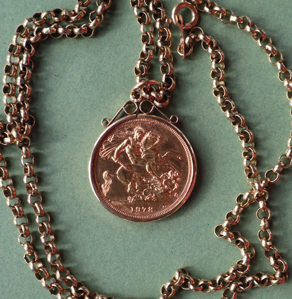 An Elizabeth II gold sovereign dated 1978 in a 9ct gold slip mount on a 9ct gold chain,