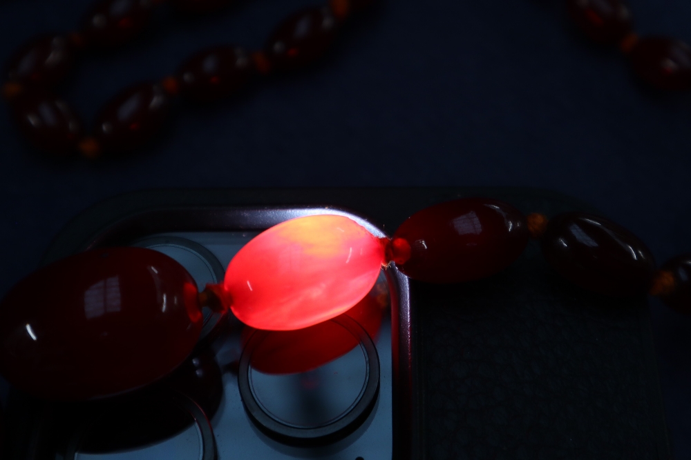 A cherry amber / bakelite beaded necklace, with graduating beads varying in size from 30mm to 10mm, - Image 6 of 9