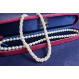 A pearl necklace with fifty nine regular pearls to a 14ct yellow gold oval basket clasp, 42.