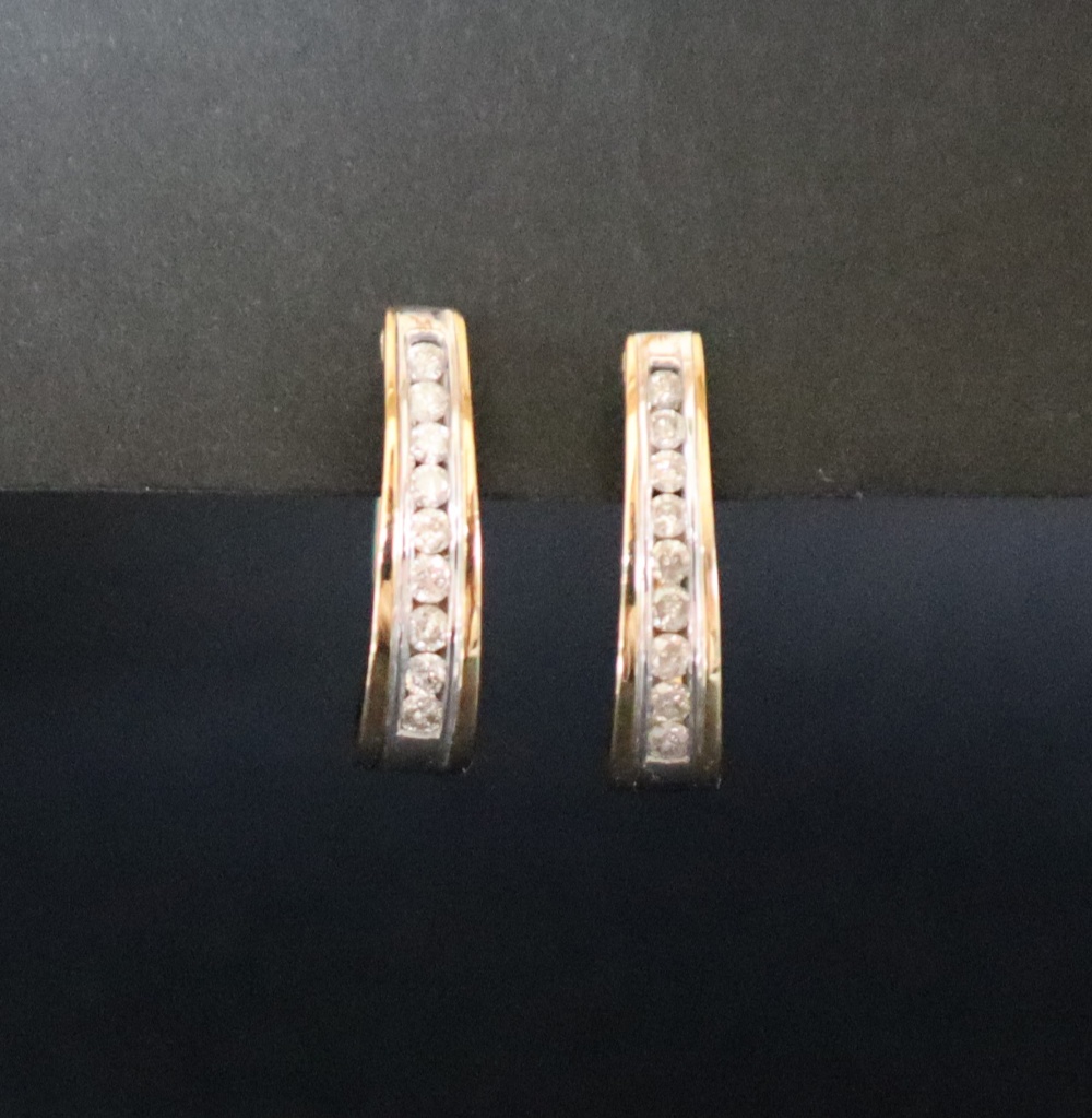 A pair of 14ct gold diamond set hoop earrings, with nine round brilliant cut diamonds, channel set, - Image 3 of 5