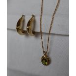 A pair of 9ct gold hoop earrings together with a 9ct gold peridot set pendant on a 9ct gold chain,