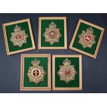A collection of five reproduction brass military helmet plates including East Yorkshire,