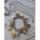 A 9ct yellow gold bracelet set with numerous charms including a lighter, telephone, miners lamp, St.