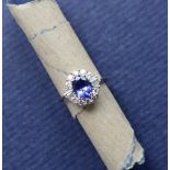 A tanzanite and diamond cluster ring, the central oval faceted tanzanite approximately 1.54ct.