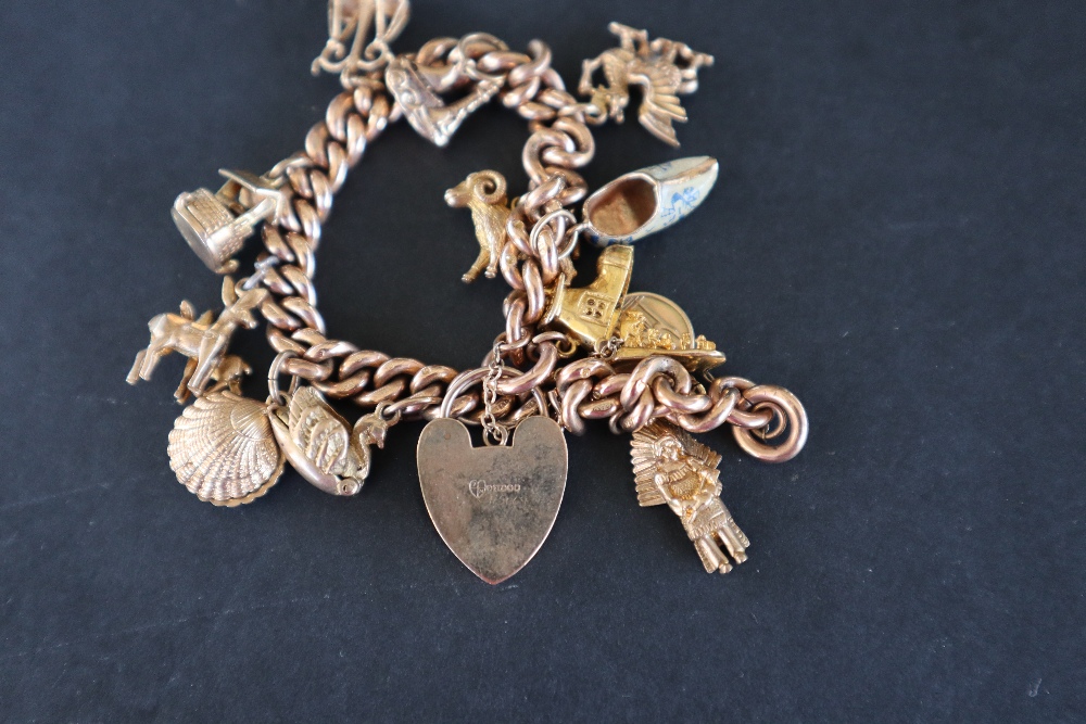 A 9ct yellow gold charm bracelet set with numerous charms including a St Christopher, Red Indian, - Image 5 of 6