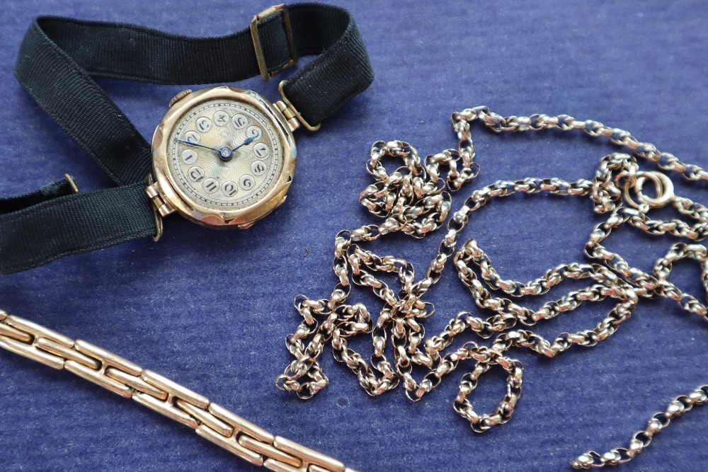 A 9ct gold lady's wristwatch on a fabric strap together with a 15ct gold expanding bracelet strap