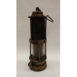 A Thomas and Williams of Aberdare Fireman's safety lamp with a domed top and pierced metal cylinder,