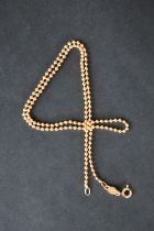 An 18ct yellow gold ball necklace, size 43.