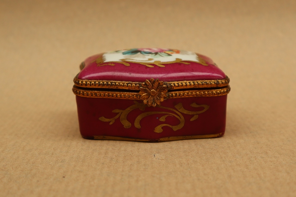 A 19th century porcelain box and cover painted with flowers to the lid and a rose pink border with - Image 2 of 7