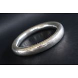 A white metal bangle, marked 925,