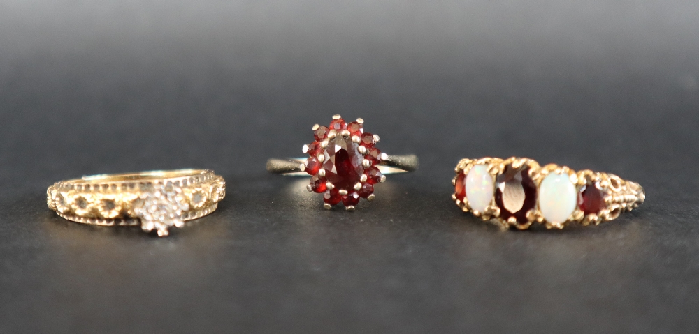 A 9ct gold dress ring set with a line of three garnets and two opals, size P 1/2, - Image 4 of 8