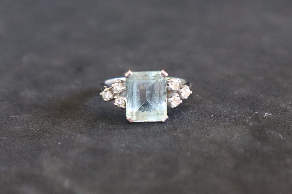 An aquamarine and diamond dress ring, set with an emerald cut aquamarine approximately 3.