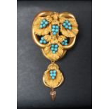 A Victorian yellow metal brooch in the form of three interlaced rings set with vine leaves and