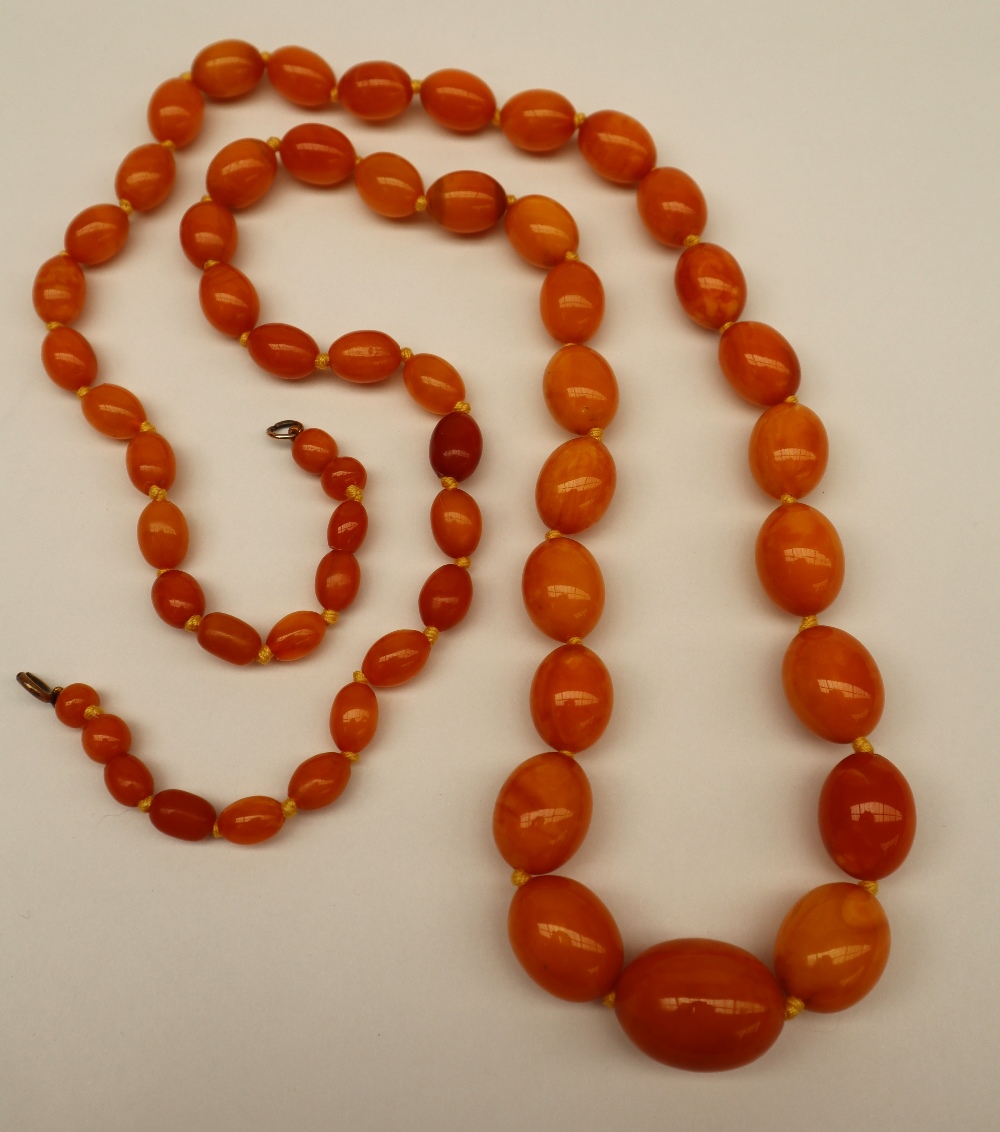 An amber bead necklace set with fifty eight graduated beads varying in size from 25mm to 6mm, - Image 2 of 2