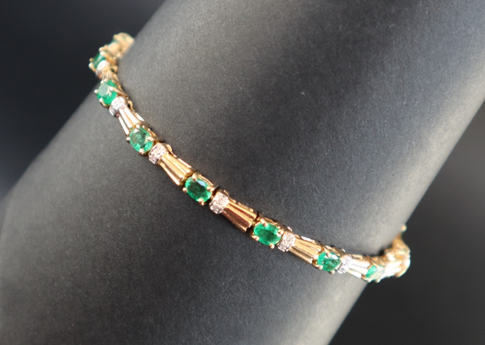An emerald and diamond tennis bracelet set with sixteen oval faceted emeralds and diamonds to a