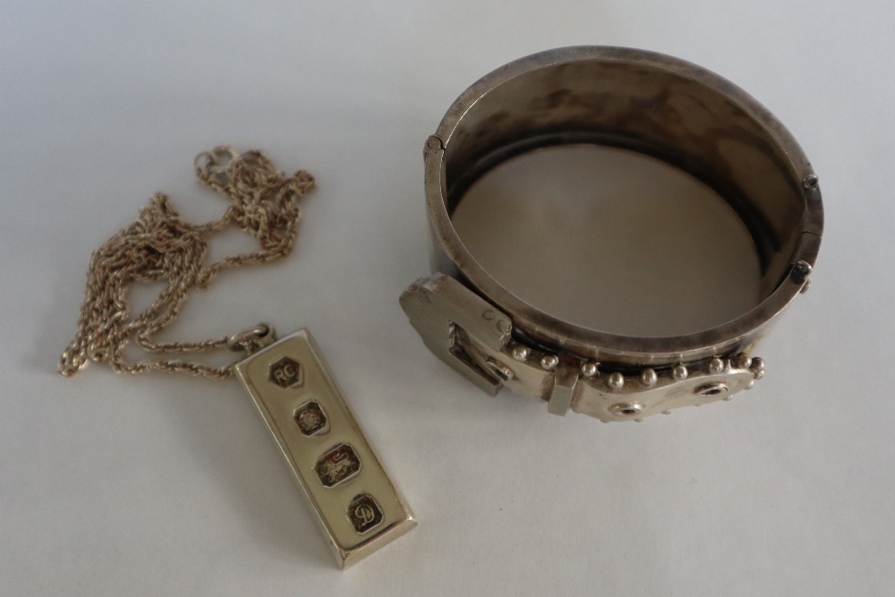 A silver ingot, Sheffield, 1978 on white metal chain, together with a silver buckle hinged bangle, - Image 3 of 5