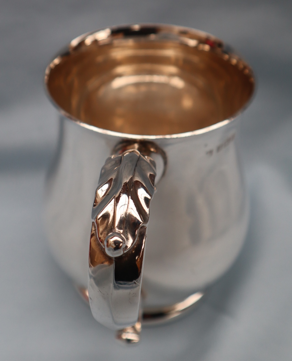 An Elizabeth II silver tankard of baluster form with a leaf capped scrolling handle on a spreading - Image 2 of 6