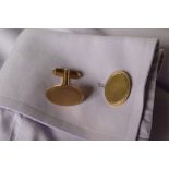 A pair of 9ct yellow gold cufflinks of oval form with engine turned decoration on a post and swivel,