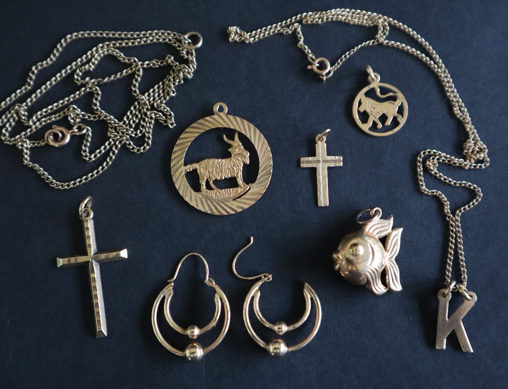 A 9ct yellow gold goat pendant together with 9ct gold crosses, other 9ct gold pendants,