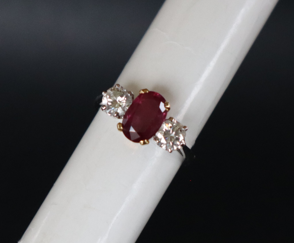 A ruby and diamond ring set with a central oval faceted ruby, approximately 9mm x 6mm, - Image 6 of 12