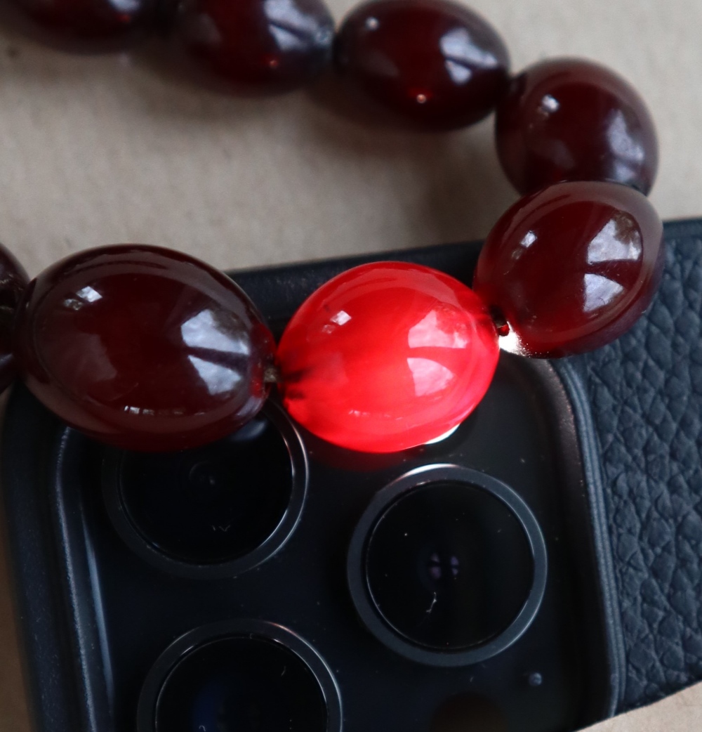 A Cherry amber / bakelite bead necklaces, with oval beads ranging in size from, 23mm to 8mm, - Image 7 of 14