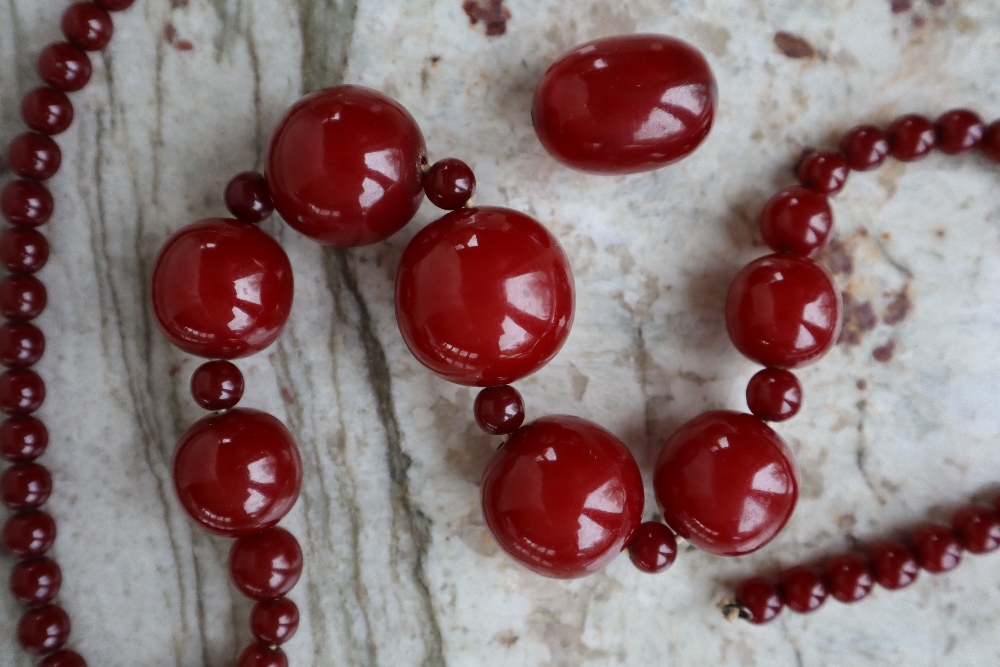 A string of cherry amber / bakelite beads,