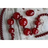 A string of cherry amber / bakelite beads,