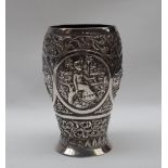 An Indian white metal beaker, decorated with figures, elephant, lion, flowers, leaves etc,