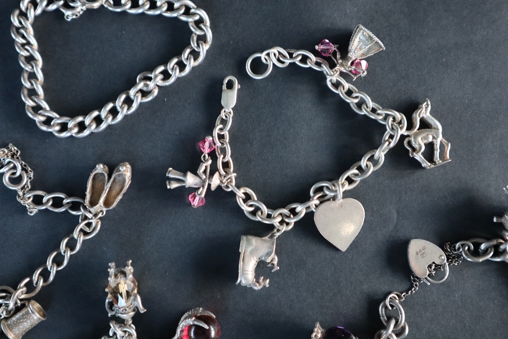 A silver charm bracelet set with numerous charms including a carriage, bird, - Image 6 of 6