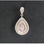 An 18ct white gold pendant set with approximately one hundred and seventy natural baguette,