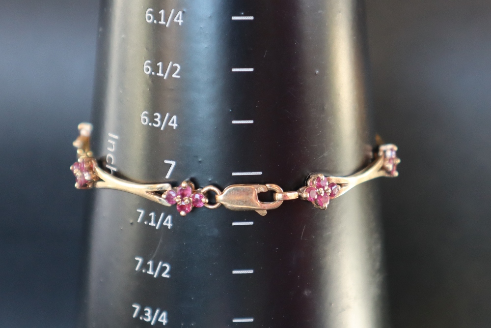 A 14ct yellow gold bracelet set with eight clusters of four rubies, 19cm long, - Image 4 of 4