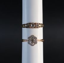 A three stone diamond ring, set with round old cut diamonds to a yellow metal setting and shank,