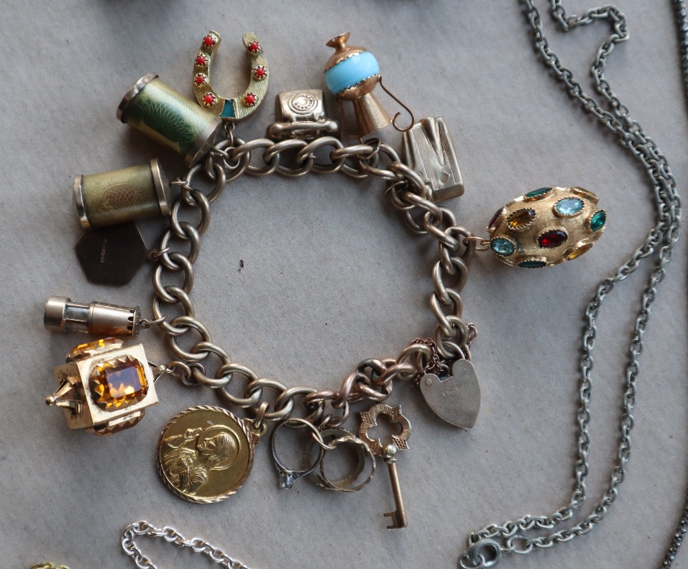 A 9ct yellow gold bracelet set with numerous charms including a lighter, telephone, miners lamp, St. - Image 3 of 3