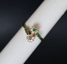 An 18ct yellow gold emerald and diamond double cluster ring set with six emeralds and twelve round