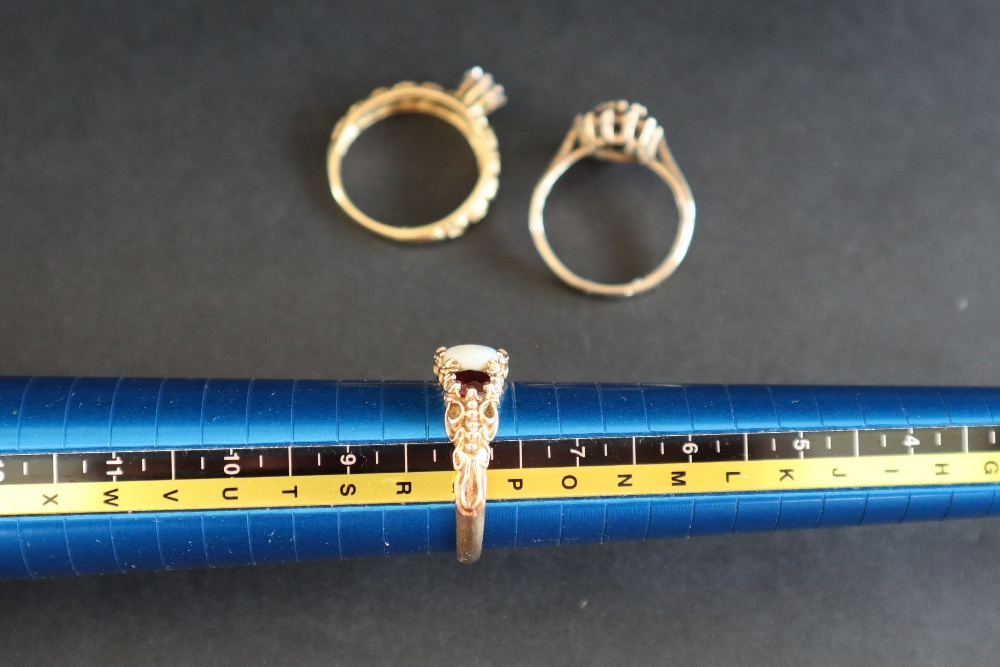 A 9ct gold dress ring set with a line of three garnets and two opals, size P 1/2, - Image 8 of 8